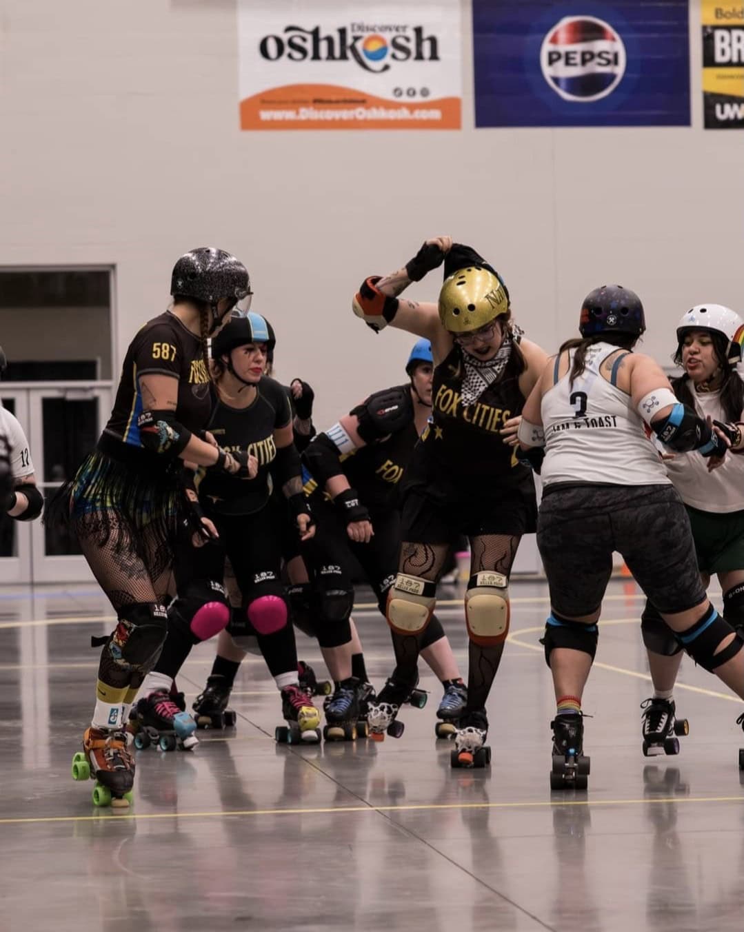 Women competing in a roller derby bout. part of Fox Cities Roller Derby